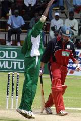 Tony Suji celebrates removing Terrence Duffin ... but Zimbabwe eventually won to level the series &copy; AFP