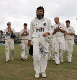 Mushtaq Ahmed leads Sussex off after taking 13 wickets in the match &copy; Getty Images