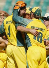 Jason Gillespie is hugged by his teammates after he picked up five wickets against Zimbabwe &copy; Getty Images